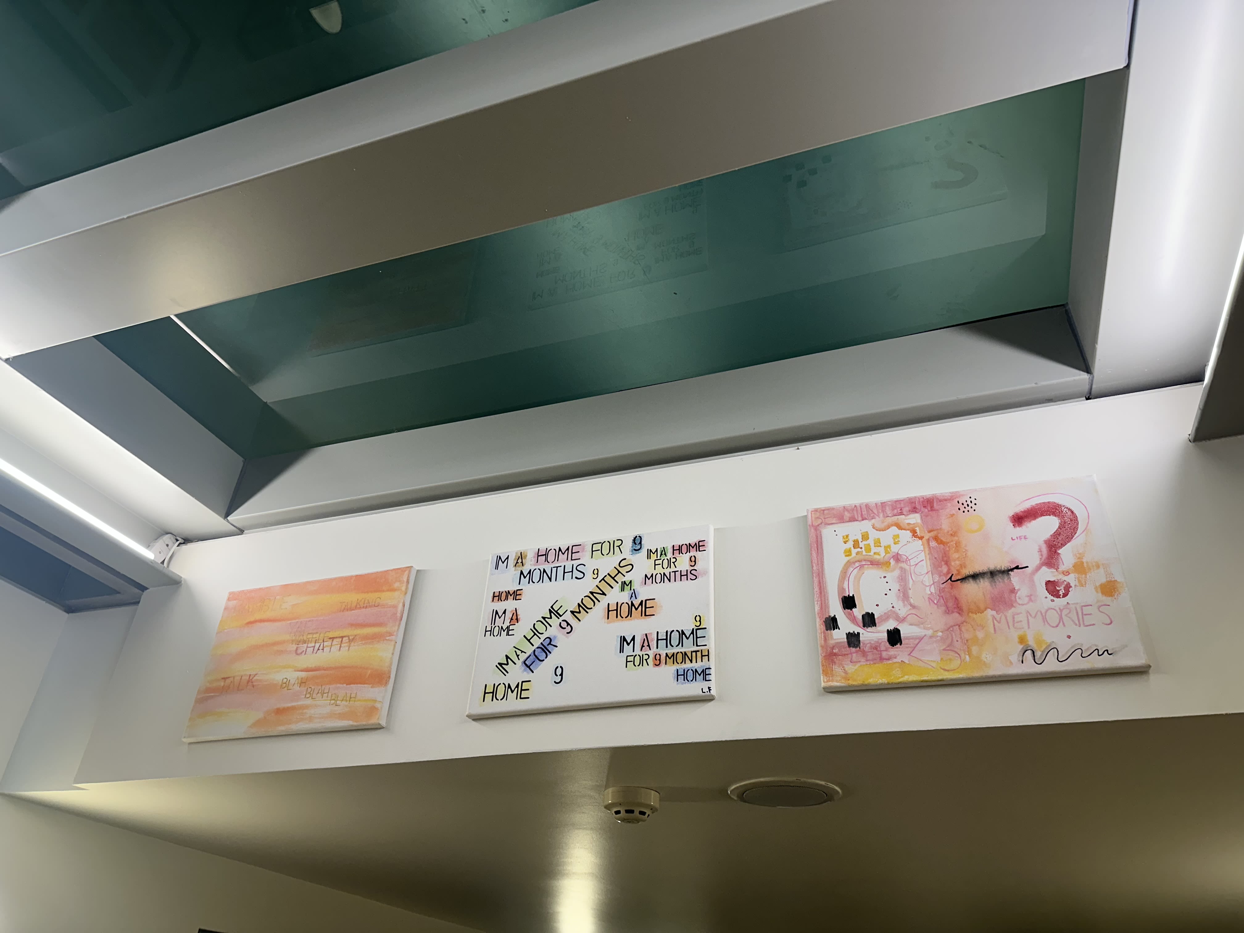 Three canvases mounted on a high wall at the Fitzwilliam Museum.